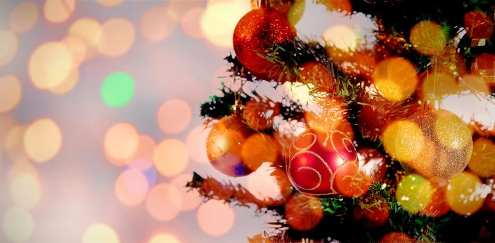 Composite image of brown parquet against christmas balls hanging in christmas tree