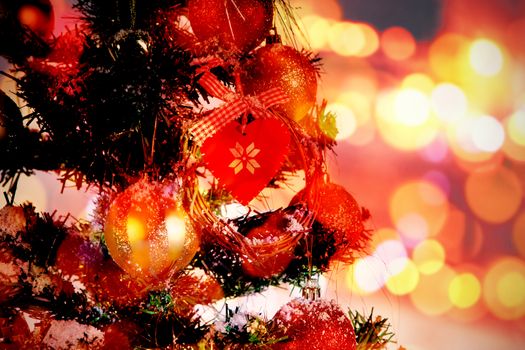 Composite image of table against christmas tree decorated with ornaments