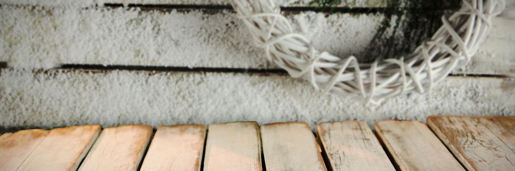 wooden boards against simple christmas crown in the snow