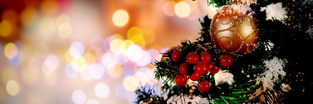 Christmas yellow circle lights against close-up of christmas tree with copy space