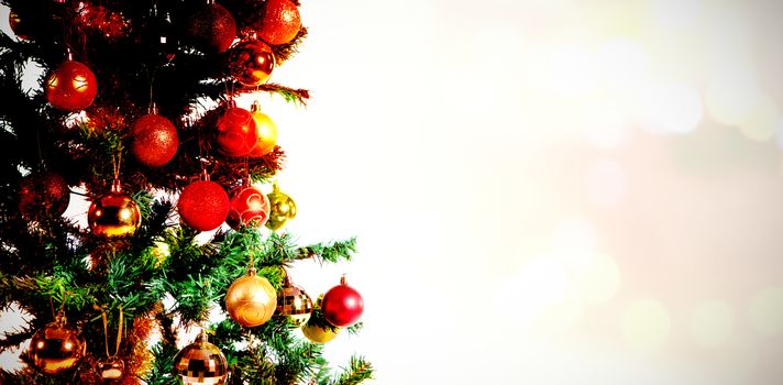 Composite image of table against christmas tree with gold ornaments
