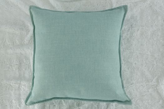 Close-up of cushion on textile