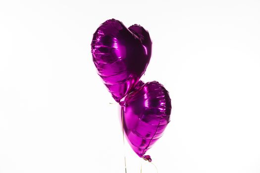 Close-up of Valentine balloons against white background
