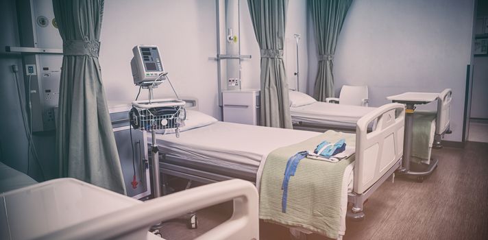 Empty hospital beds in ward of hospital