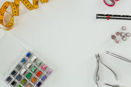 Overhead of thread rolls and various tools on white background