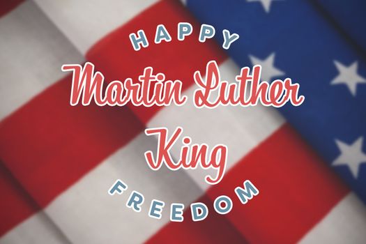 happy Martin Luther King freedom against close-up of folded american flag