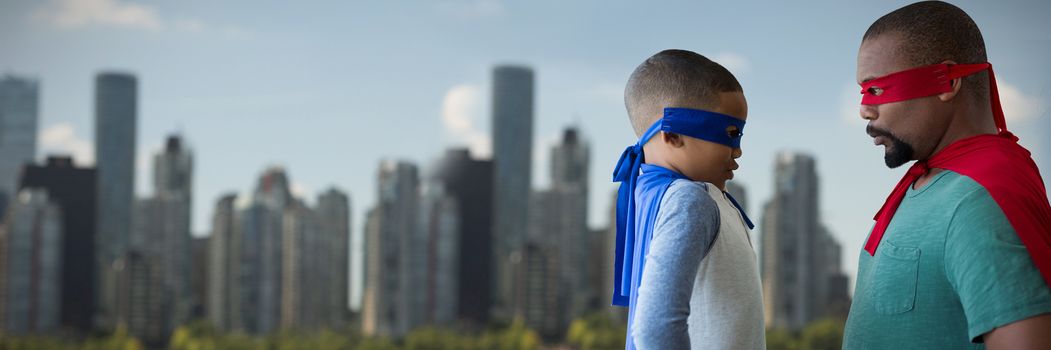 Father and son pretending to be superhero against skyline at the river coast