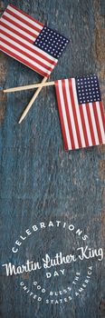 Martin Luther king day against two american flags on a wooden table
