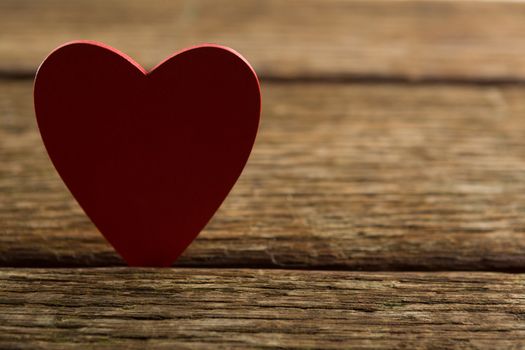 Close-up of heart shape decoration on wooden plank