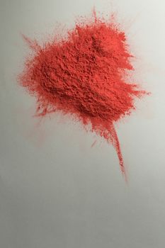 Overhead of red color powder on white background
