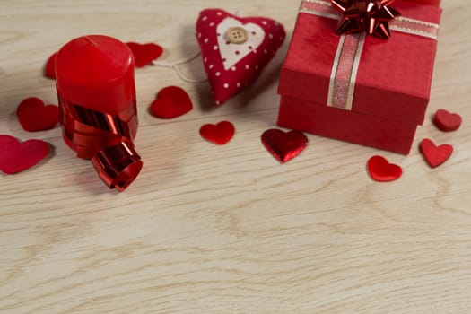 Close-up of gift boxes and heart shape decorations on wooden table