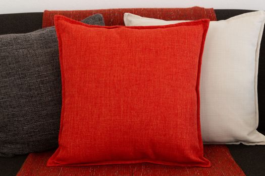 Close-up of cushions and blanket arranged on sofa