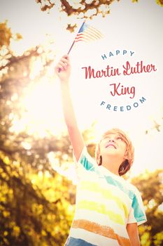 Boy looking at American flag against happy martin luther king freedom