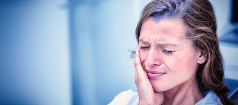 Unhappy woman having a toothache  in dental clinic