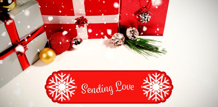 Banner sending love against christmas gifts against white background