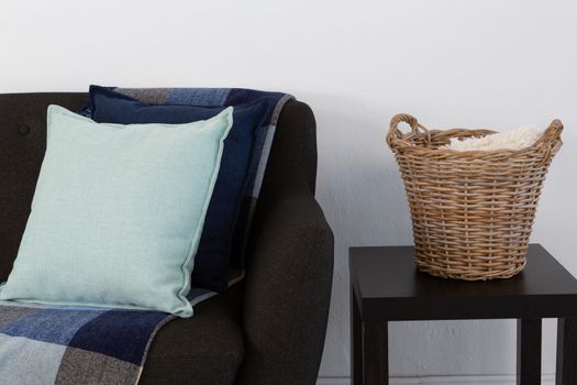 Close-up of cushions and blanket arranged on sofa