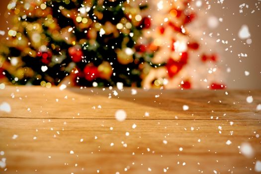 Snow falling against close-up of wooden table