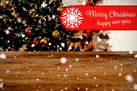 Banner Merry Christmas against wooden table in christmas tree in background