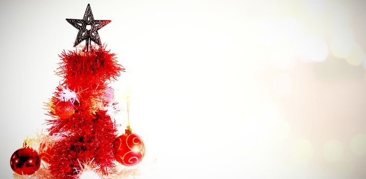 Composite image of table against christmas star in tree