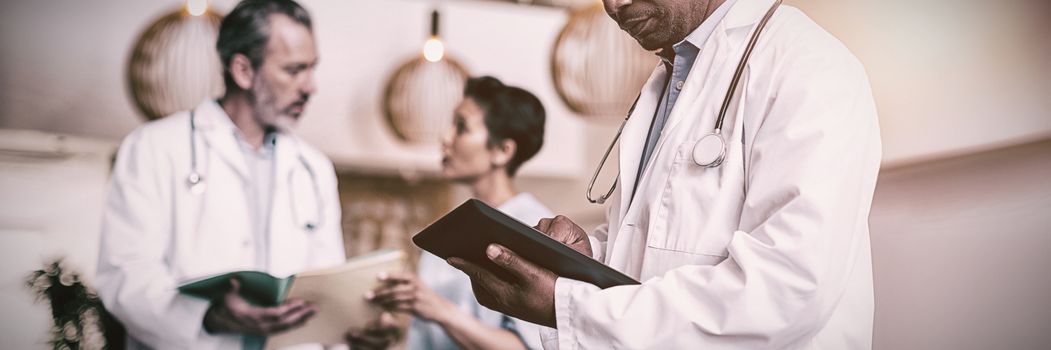 Doctor using digital tablet in hospital