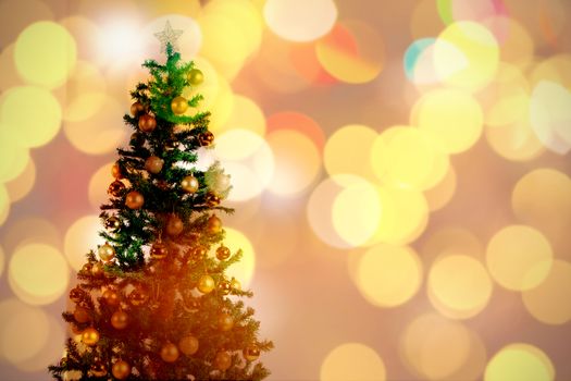Defocused of Christmas tree lights and fireplace against christmas tree with ornaments