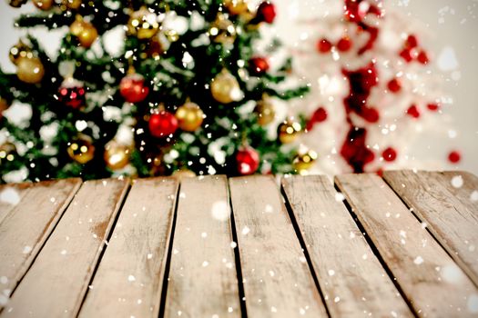 Snow falling against close-up of wooden table