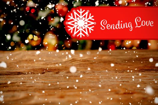 Banner sending love against unfocused christmas tree with copy space
