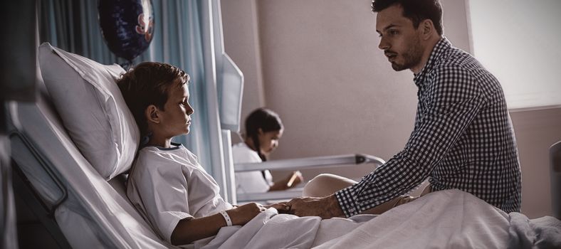 Father comforting his son at hospital