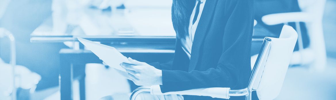 Portrait of businesswoman using digital tablet in office