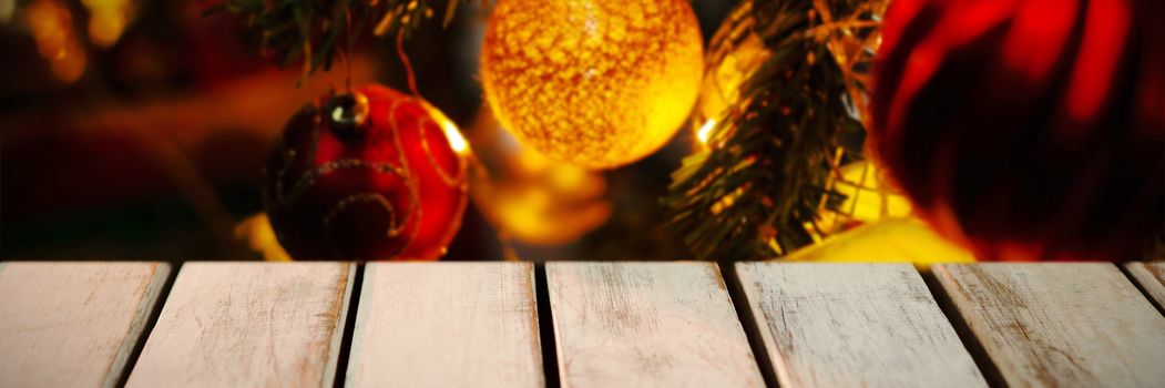 wooden boards against christmas decoration hanging in tree