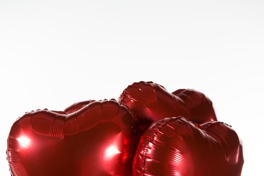 Close-up of Valentine balloons against white background