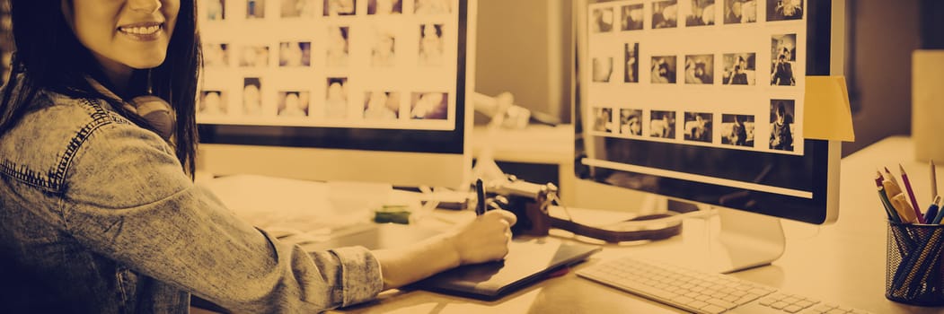 Portrait of businesswoman smiling while working at creative office