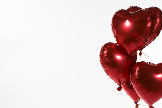 Close-up of Valentine balloons against white background