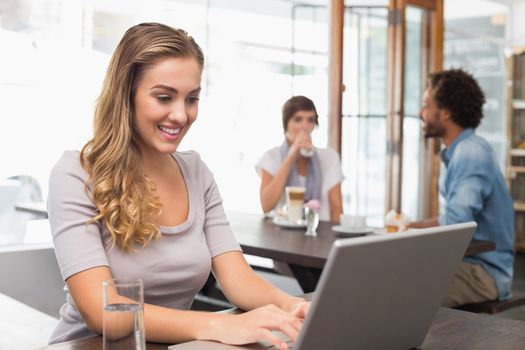 Pretty blonde using her laptop at the coffee shop