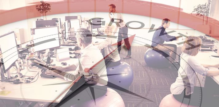 Compass pointing to growth against business people sitting on exercise balls while working in office