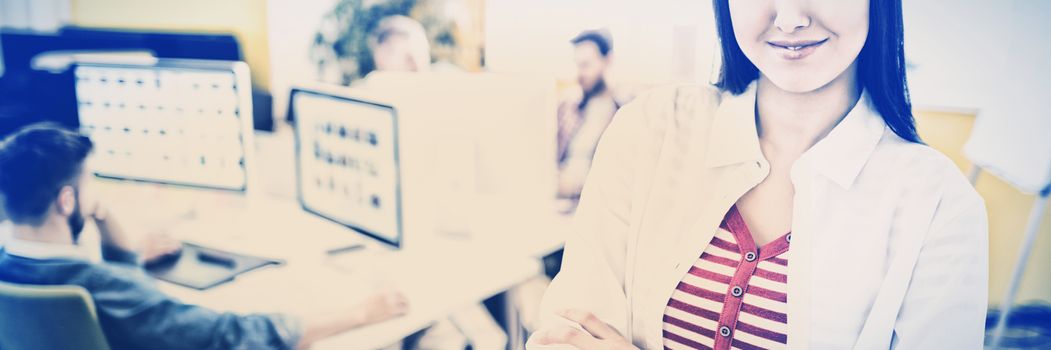 Portrait of beautiful young female executive standing at editing office