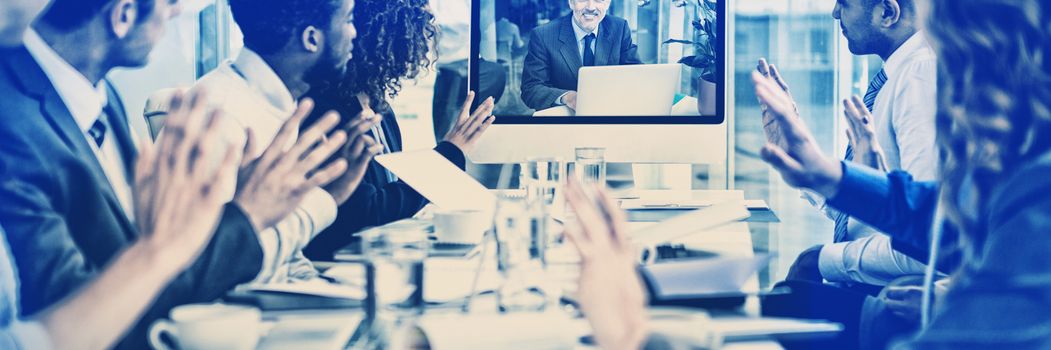 Business people looking at screen during video conference in office