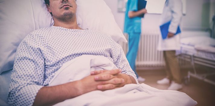 Ill patient lying on bed in hospital