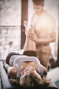 Woman receiving leg massage from physiotherapist in clinic