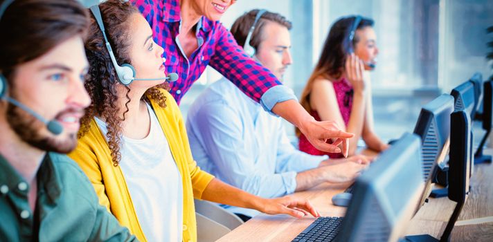 Customer service executive trainer assisting her team at office