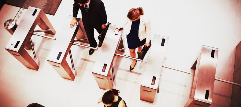 Top view of business executives passing through turnstile gate