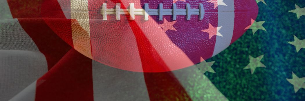 Close-up of red American football against close-up of crumbled american flag
