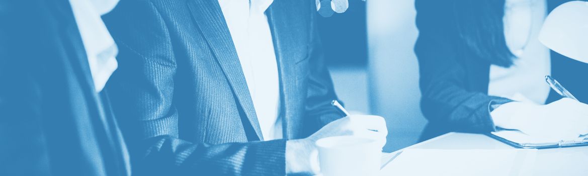 Group of businesspeople looking at document in office