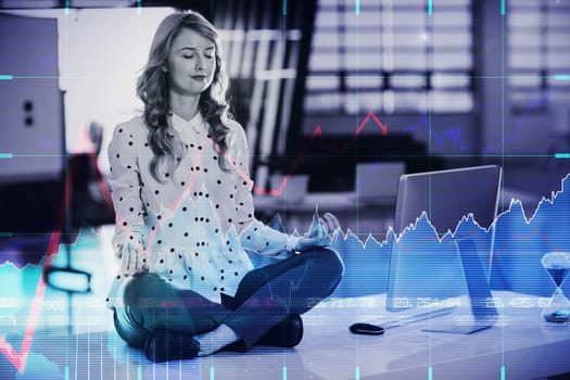 Stocks and shares against businesswoman doing yoga in office