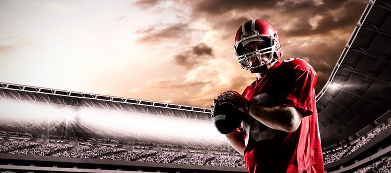 American football player standing with helmet preparing to throw ball against composite image of stadium with cloudy sky