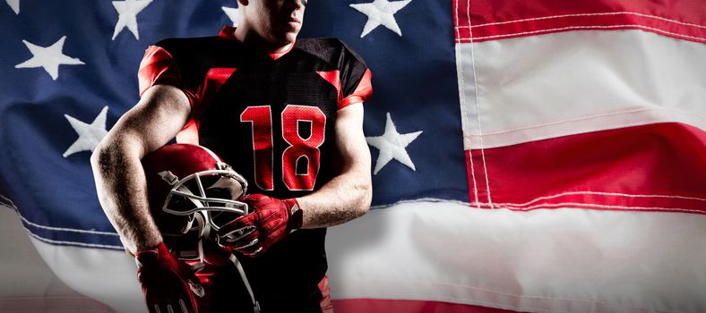 American football player holding rugby helmet against full frame of american flag