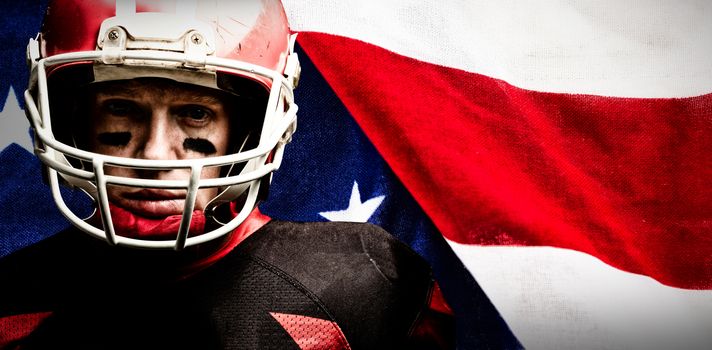 American football player standing in helmet against close-up of an american flag