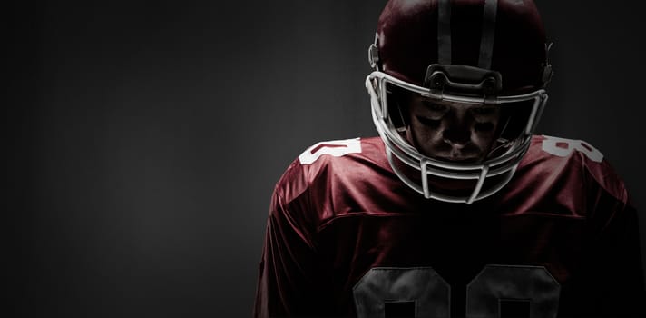 American football player standing in rugby helmet against full frame shot of patterned white wall