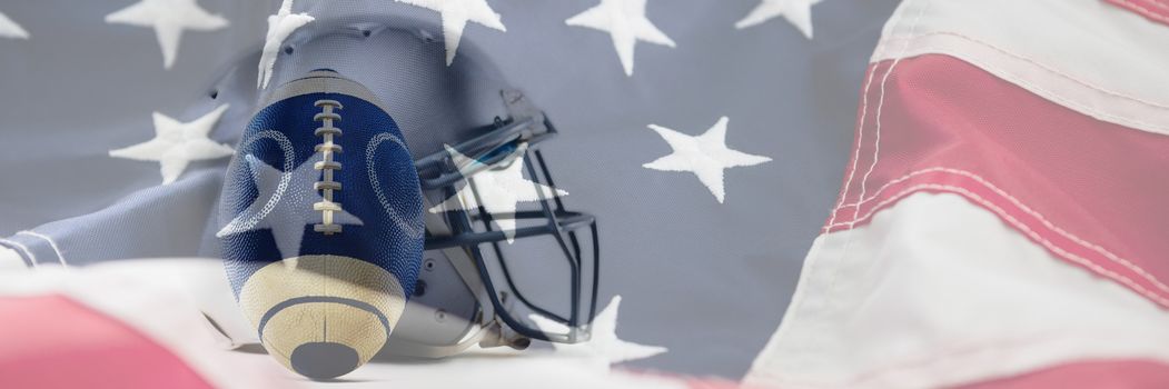 Close-up of sports helmet and football against full frame of american flag