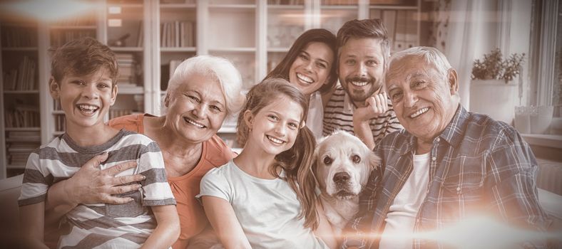 Portrait of happy multi generation family sitting on sofa in living room at home